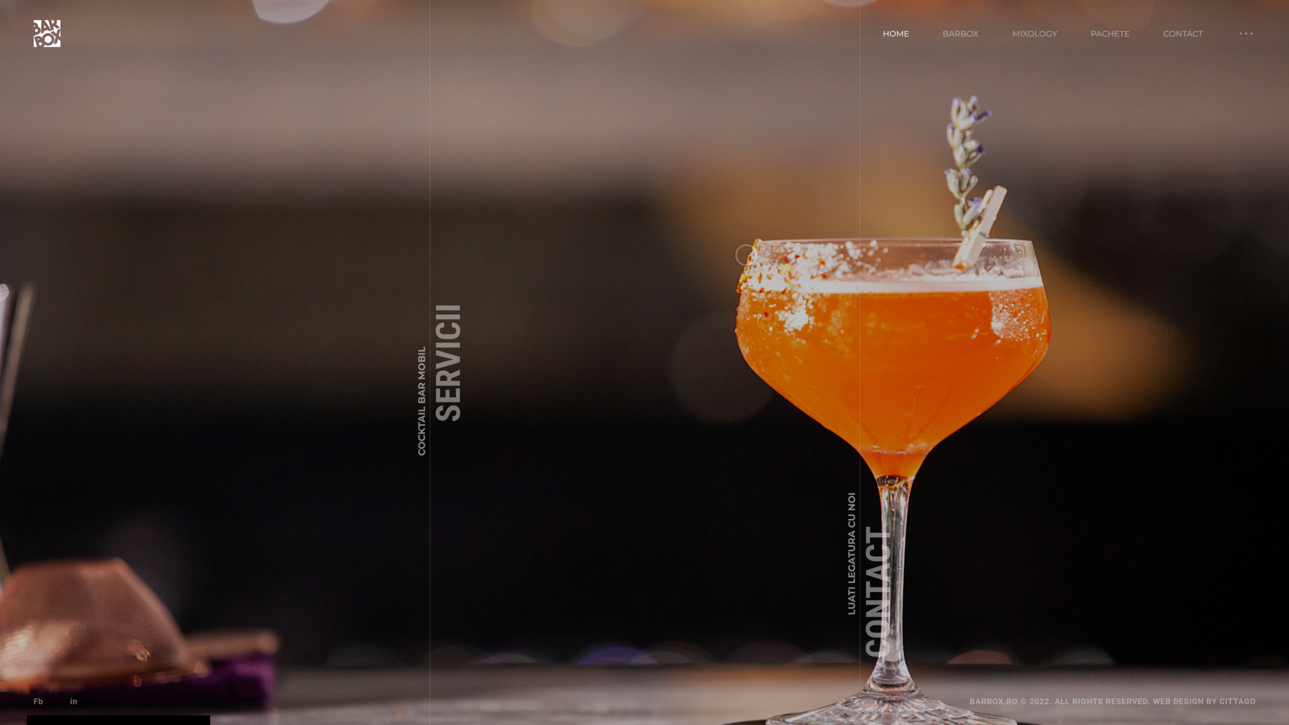 A single amber cocktail catching the low light of a dim bar