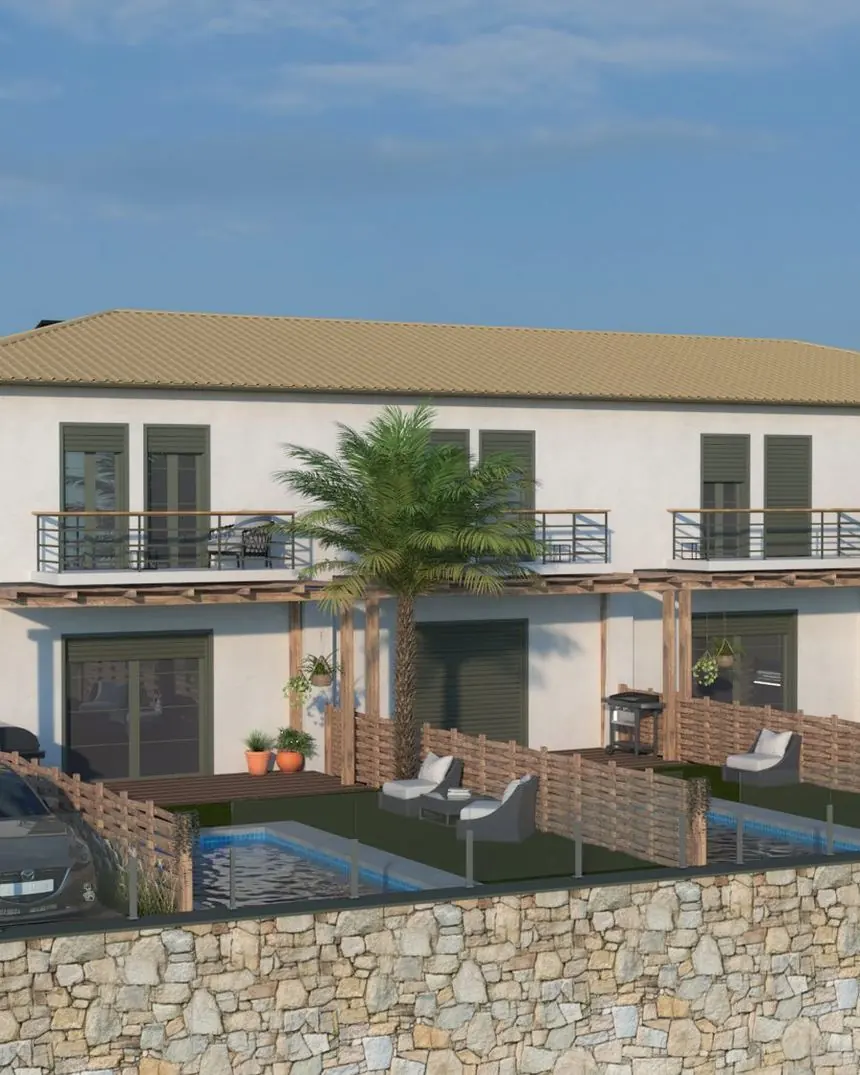 The Ela Home development seen from the approach road — four pools, stone retaining wall, olive terraces