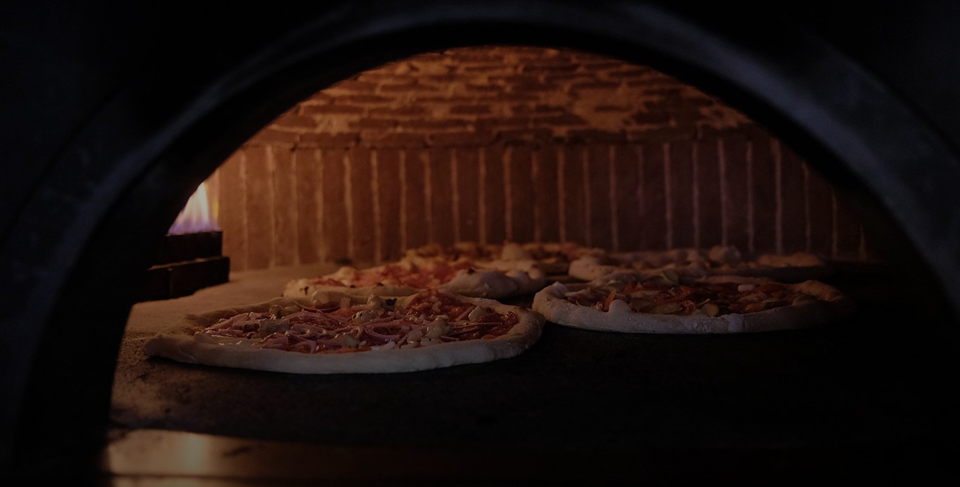 Pizza blistering in the wood-fired Visciano oven's open flame
